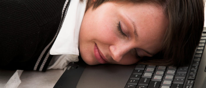 woman sleeping on laptop