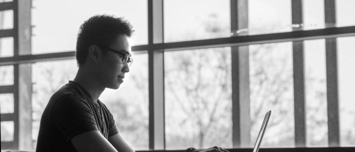 Young man in front of laptop.